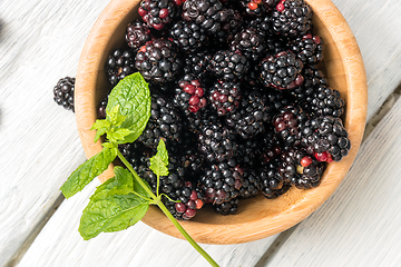 Image showing Wooden cup with Blackberries