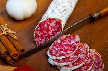 Image showing traditional Italian salame cured sausage sliced on a wood board