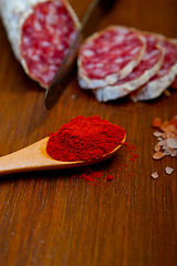 Image showing traditional Italian salame cured sausage sliced on a wood board