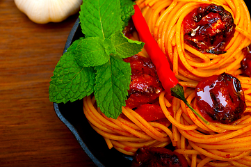 Image showing italian spaghetti pasta and tomato with mint leaves