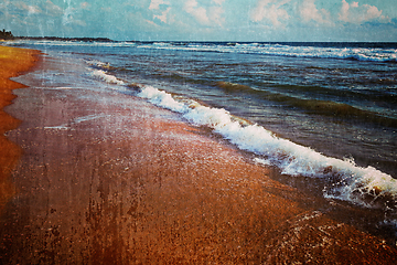 Image showing Wave surging on sand