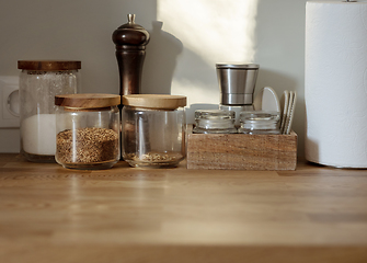 Image showing various containers on kitchen table