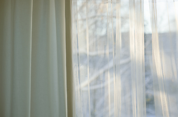 Image showing curtains hang in front of window