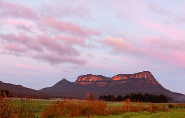 Image showing Rocky mountain wilderness with soft pinky orange sky