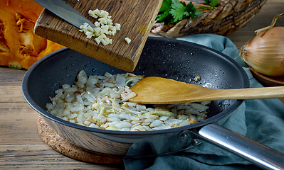 Image showing fresh chopped garlic is added to fried onions