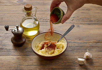 Image showing adding paprika powder to garlic butter