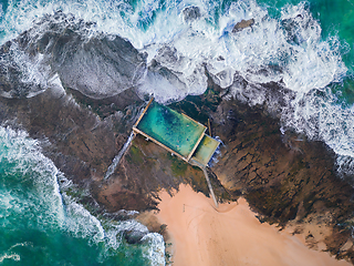 Image showing Tidal swimming pool built on a rock shelf surrounded by ocean