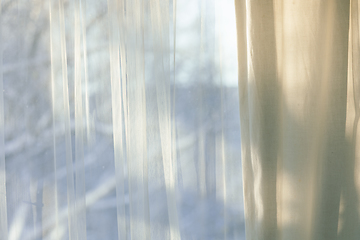 Image showing curtains hang in front of window