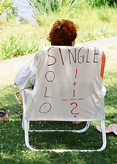 Image showing Female sitting outside.