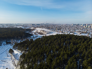 Image showing Aerial view of winter forest and city