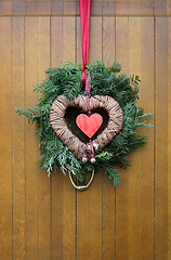 Image showing Traditional christmas wreath on a wooden door