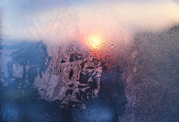 Image showing Ice pattern, water drops and sunlight on a frozen winter window