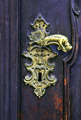 Image showing Vintage wooden door with decorative handle and keyhole