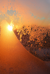 Image showing Beautiful sunrise and ice patterns on winter window pane