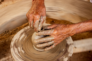 Image showing Potter at work makes ceramic dishes. India, Rajasthan.