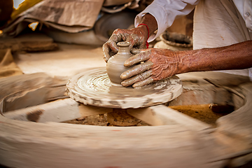 Image showing Potter at work makes ceramic dishes. India, Rajasthan.