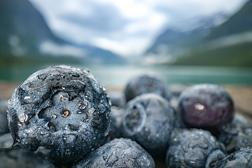 Image showing Blueberry antioxidants on a wooden table on a background of Norw