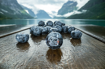 Image showing Blueberry antioxidants on a wooden table on a background of Norw