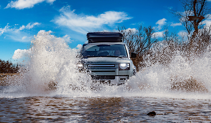 Image showing Off road tourist car rides off-road in the highlands. Expedition