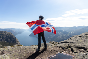 Image showing Woman with a waving flag of Norway on the background of nature