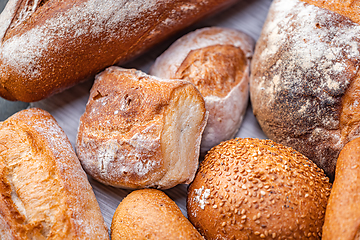 Image showing Freshly baked natural bread is on the kitchen table.