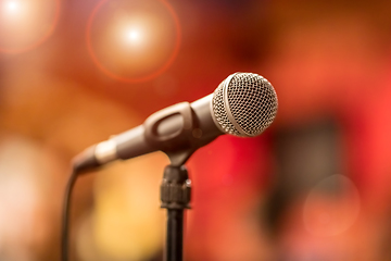 Image showing Microphone on stage against a background of auditorium.