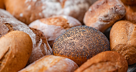 Image showing Freshly baked natural bread is on the kitchen table.