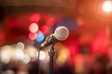 Image showing Microphone on stage against a background of auditorium.