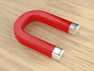 Image showing Horseshoe magnet on wooden desk