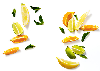 Image showing Sliced citrus fruits and mint leaves on a white background