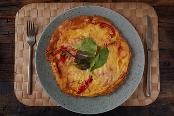 Image showing Omelet with green onion on wood table. Fresh ingredient of egg and onion. Delicious dish. Easy to cook. Popular in Thailand food. Still life food.