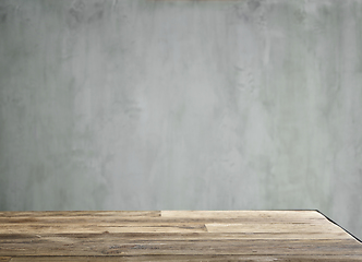 Image showing Wooden table and grey wall 