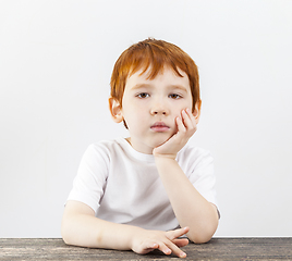 Image showing a portrait of a boy who holds his head