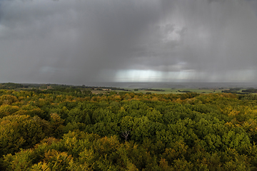 Image showing Rain clouds and rain over autumn landscape