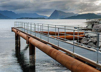 Image showing pier on the coast with mountains