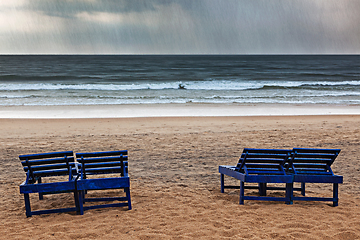 Image showing Beach chairs under rain