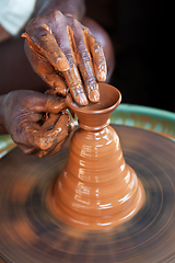 Image showing Potter throwing