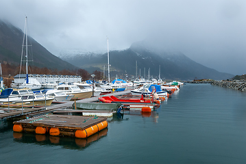 Image showing boats in marina with sun through cloud cover