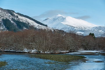 Image showing snow-covered mountains and river in the foreground