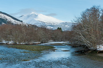 Image showing snow-covered mountains and river in the foreground