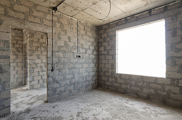 Image showing Construction of an individual residential building, view of two walls, interior with a doorway and exterior with a window opening