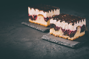 Image showing German cake Donauwelle (Danube waves) - vanilla and chocolate sponge cake with sour cherries, vanilla buttercream and chocolate icing 