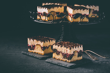 Image showing German cake Donauwelle (Danube waves) - vanilla and chocolate sponge cake with sour cherries, vanilla buttercream and chocolate icing 