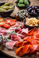 Image showing Charcuterie board with prosciutto ham, salami, olives and tapas