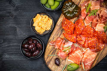 Image showing Charcuterie board with prosciutto ham, salami, olives and tapas