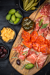 Image showing Charcuterie board with prosciutto ham, salami, olives and tapas