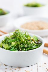 Image showing Wakame seaweed salad with sesame seeds. Traditional Japanese food.