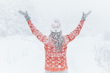 Image showing Woman out in the forest with heavy snow falling