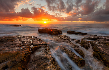 Image showing Tangerine sunrise over the ocean