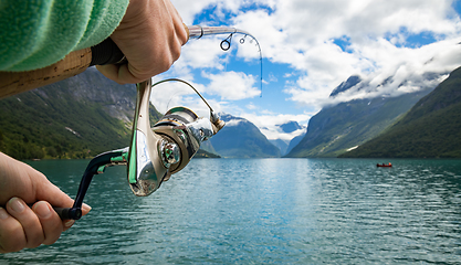 Image showing Woman fishing on Fishing rod spinning in Norway.